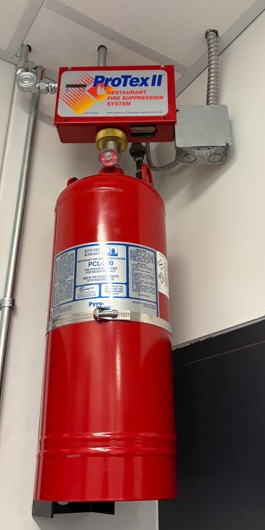 Mismatched ProTex II control head on a PyroChem Kitchen Knight II cylinder, red-tagged by Boss Fire Protection in Dallas, TX