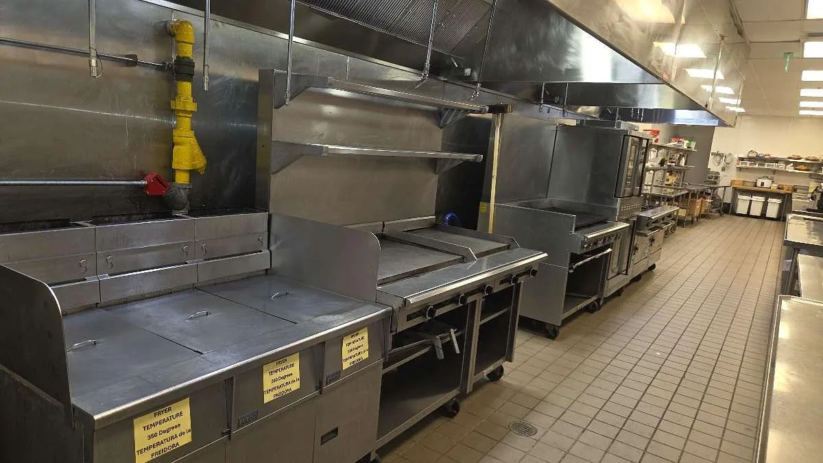 Commercial kitchen hood with full fire suppression nozzle coverage installed by Boss Fire Protection in Dallas-Fort Worth, TX