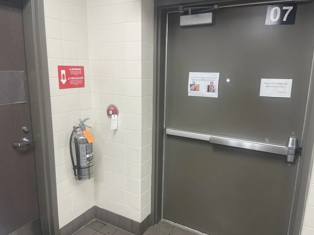 Boss Fire Protection setting the manual pull station on the path of egress for a commercial kitchen fire suppression system in Dallas-Fort Worth, TX