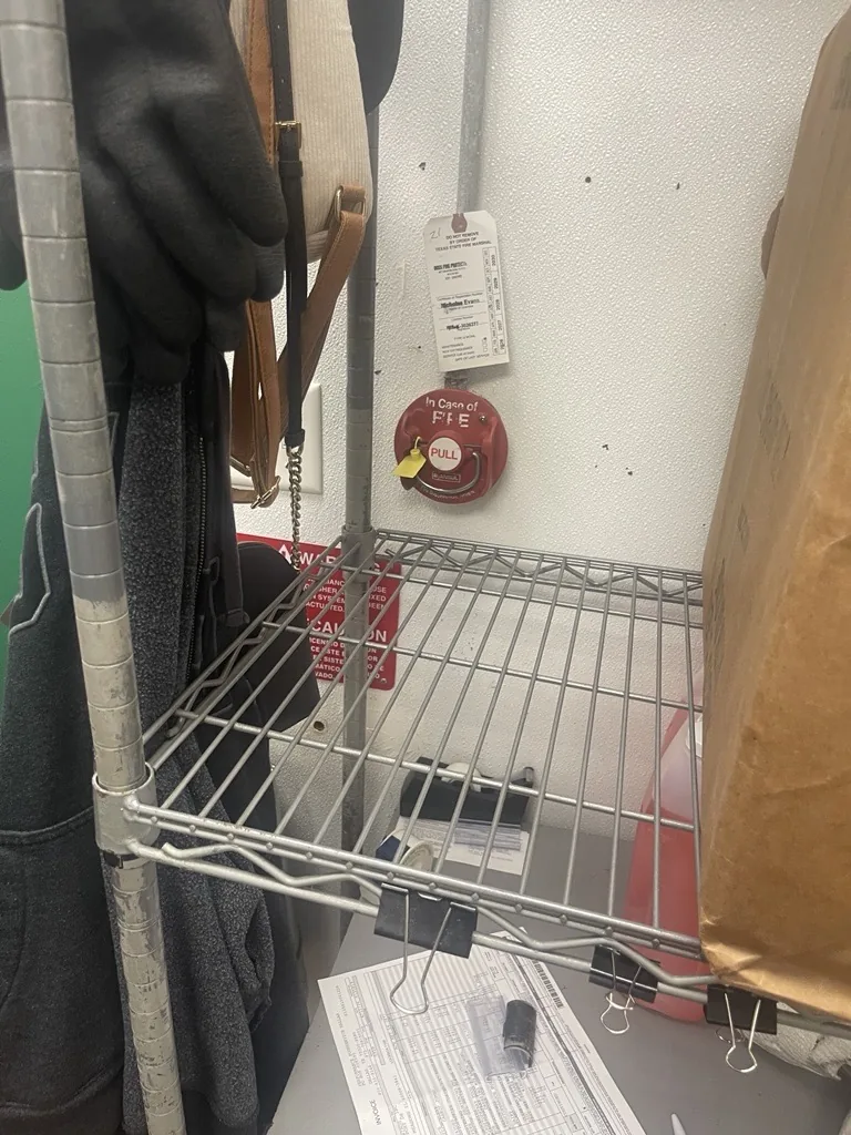 Boss Fire Protection verifying a commercial kitchen fire suppression manual pull station after a repair in Dallas-Fort Worth, TX