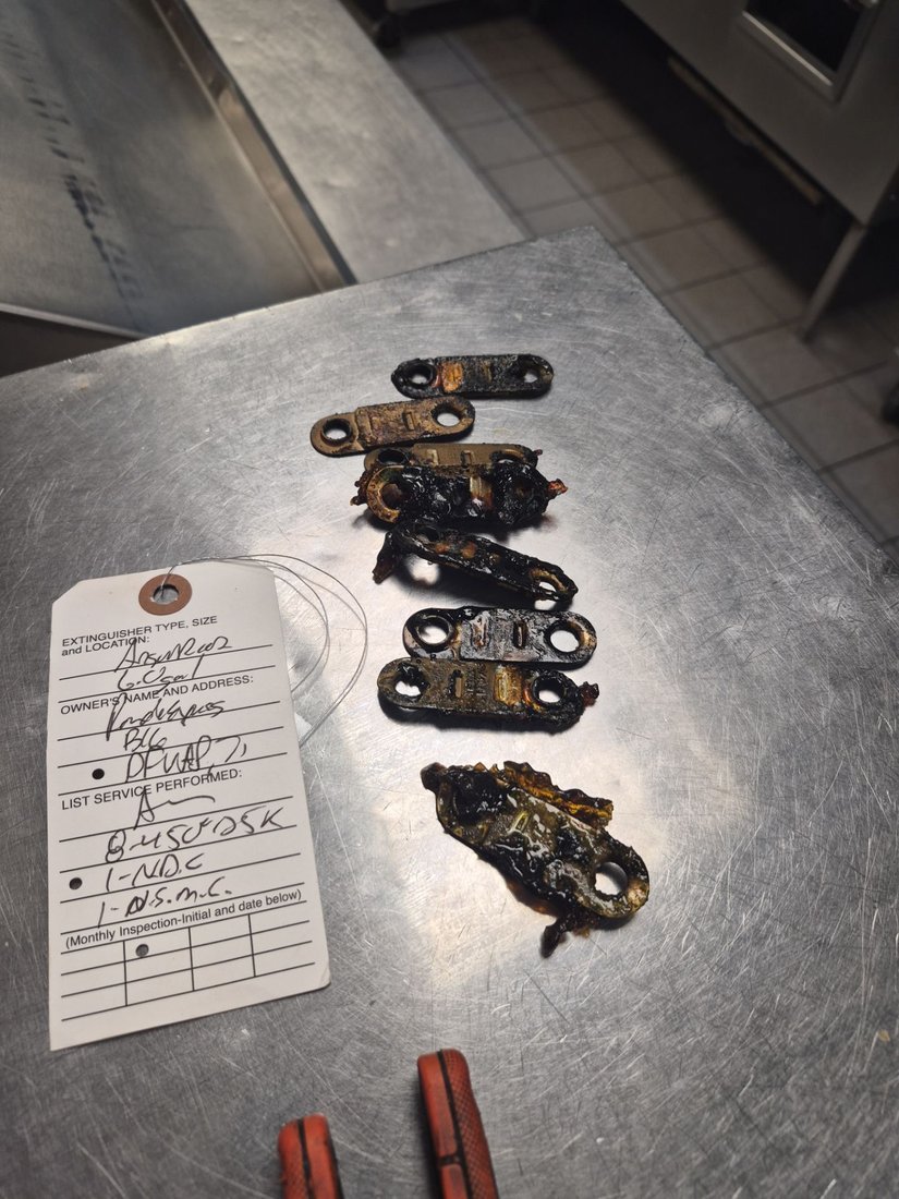 Expired fusible links removed from a commercial kitchen fire suppression system during routine maintenance by Boss Fire Protection in Dallas, TX