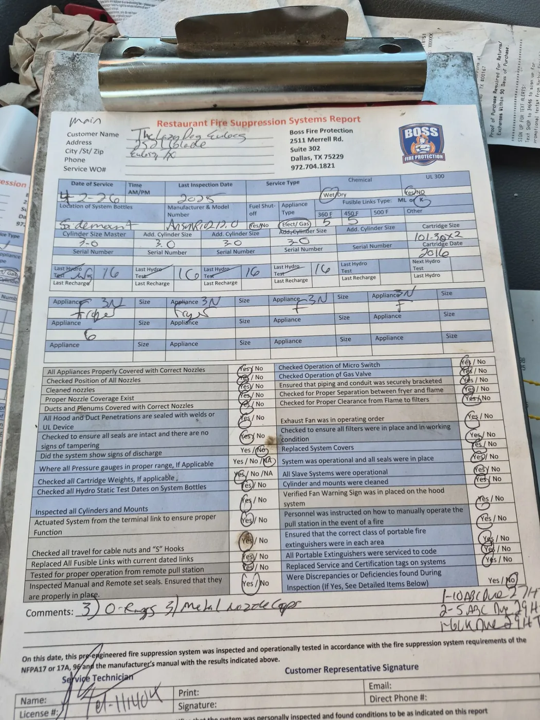 A completed Boss Fire Protection restaurant fire suppression system service report filled out on site in Dallas-Fort Worth, TX
